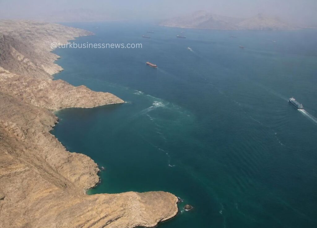 Aerial view of a rocky coastline with several ships sailing on blue water.